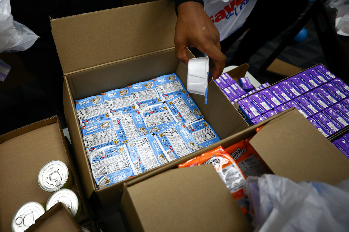 Kentucky football players pack lunches for God’s Pantry Food Bank.

Photo by Elliott Hess | UK Athletics