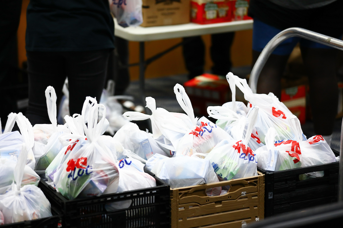 Kentucky football players pack lunches for God’s Pantry Food Bank.

Photo by Elliott Hess | UK Athletics