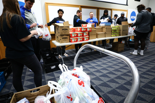 Kentucky football players pack lunches for God’s Pantry Food Bank.

Photo by Elliott Hess | UK Athletics