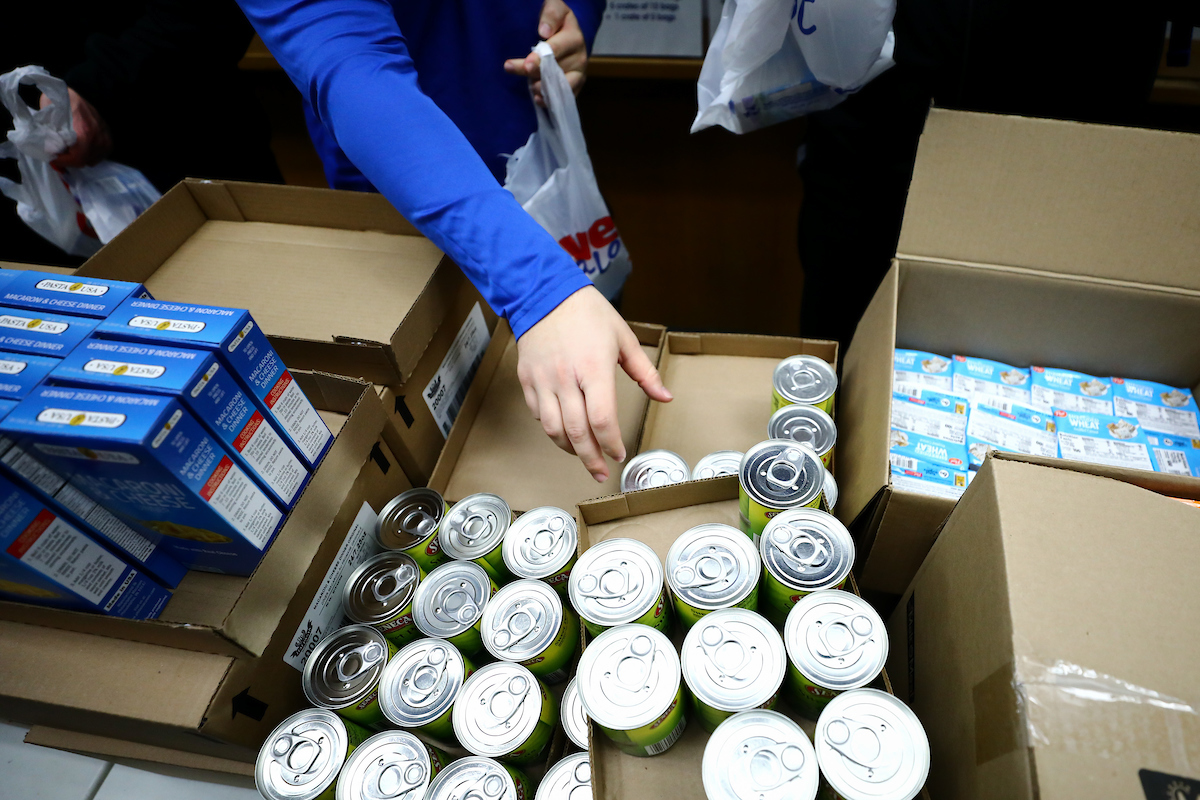 Kentucky football players pack lunches for God’s Pantry Food Bank.

Photo by Elliott Hess | UK Athletics