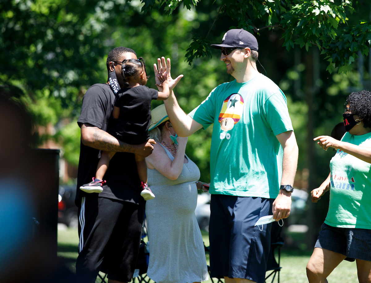 Former player Lukasz Obrzut, high fives a little girl held by Erik Daniels, before the Walk Forward rally on June 13, 2020. Photo by Mark Cornelison | UKphoto