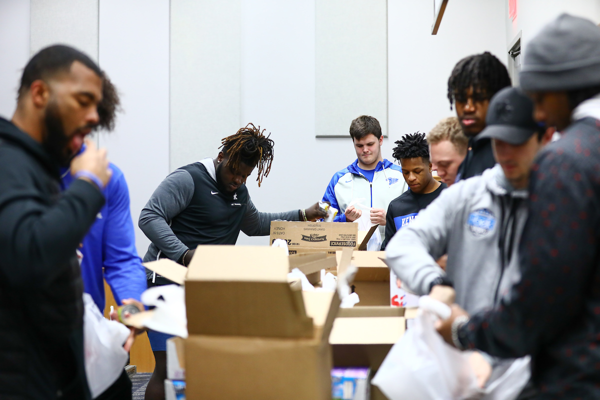 Kentucky football players pack lunches for God’s Pantry Food Bank.

Photo by Elliott Hess | UK Athletics