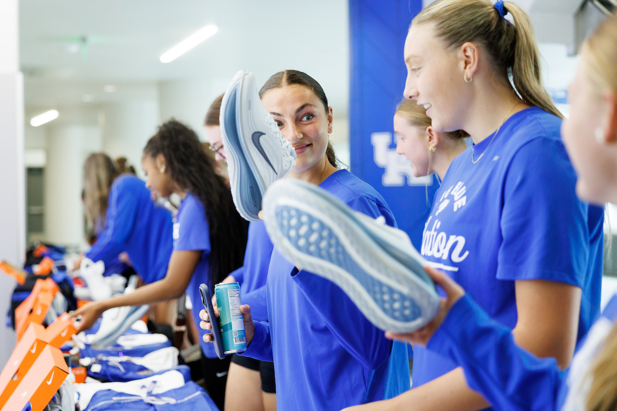 A picture of Bellamie Beus showing a teammate her new shoes