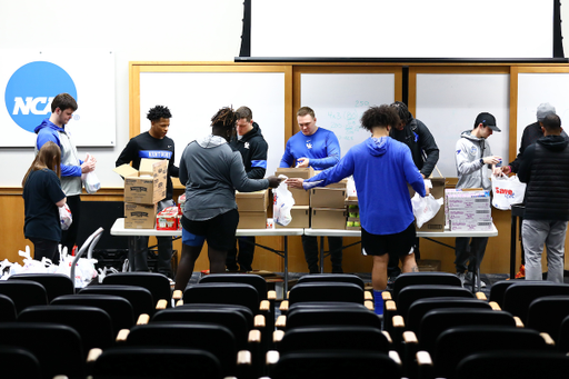Kentucky football players pack lunches for God’s Pantry Food Bank.

Photo by Elliott Hess | UK Athletics
