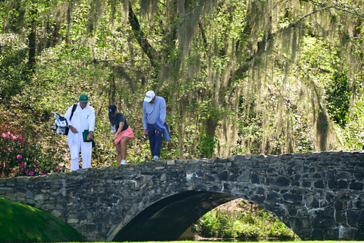 Jensen Castle of the United States feeds fish on the Nelson Bridge on No. 13 during a practice round for the Augusta National Women's Amateur at Augusta National Golf Club, Friday, April 1, 2022.