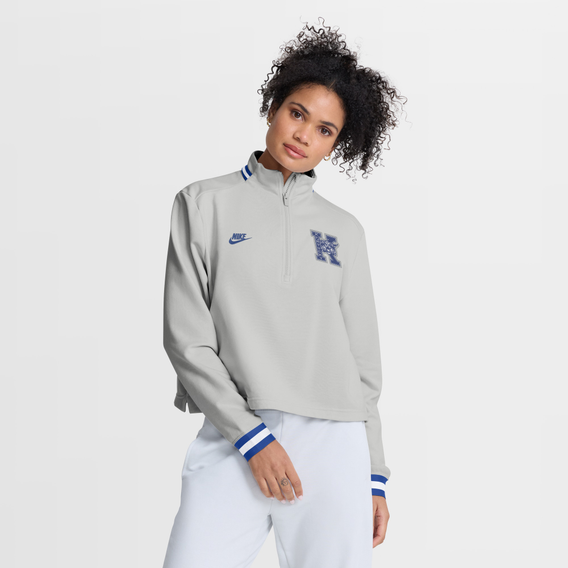 A picture of a woman wearing a quarter zip sweathshirt