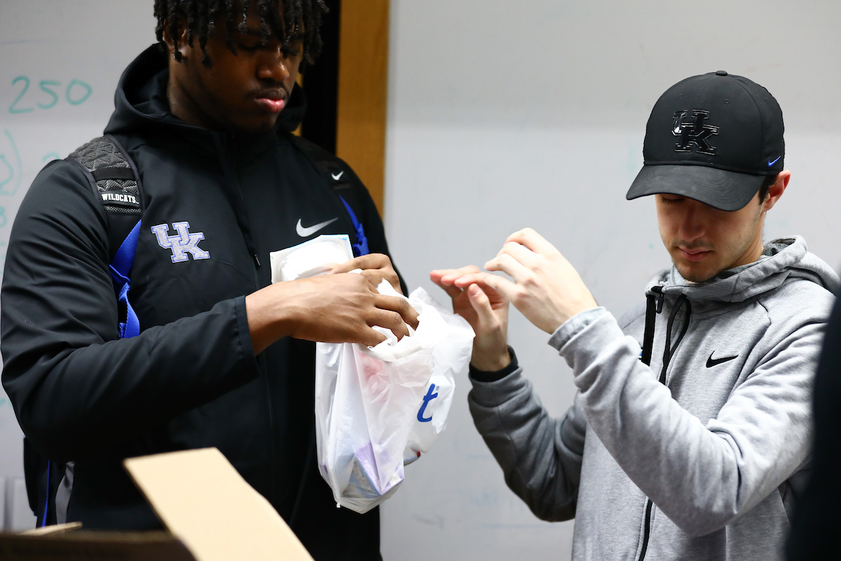 Kentucky football players pack lunches for God’s Pantry Food Bank.

Photo by Elliott Hess | UK Athletics