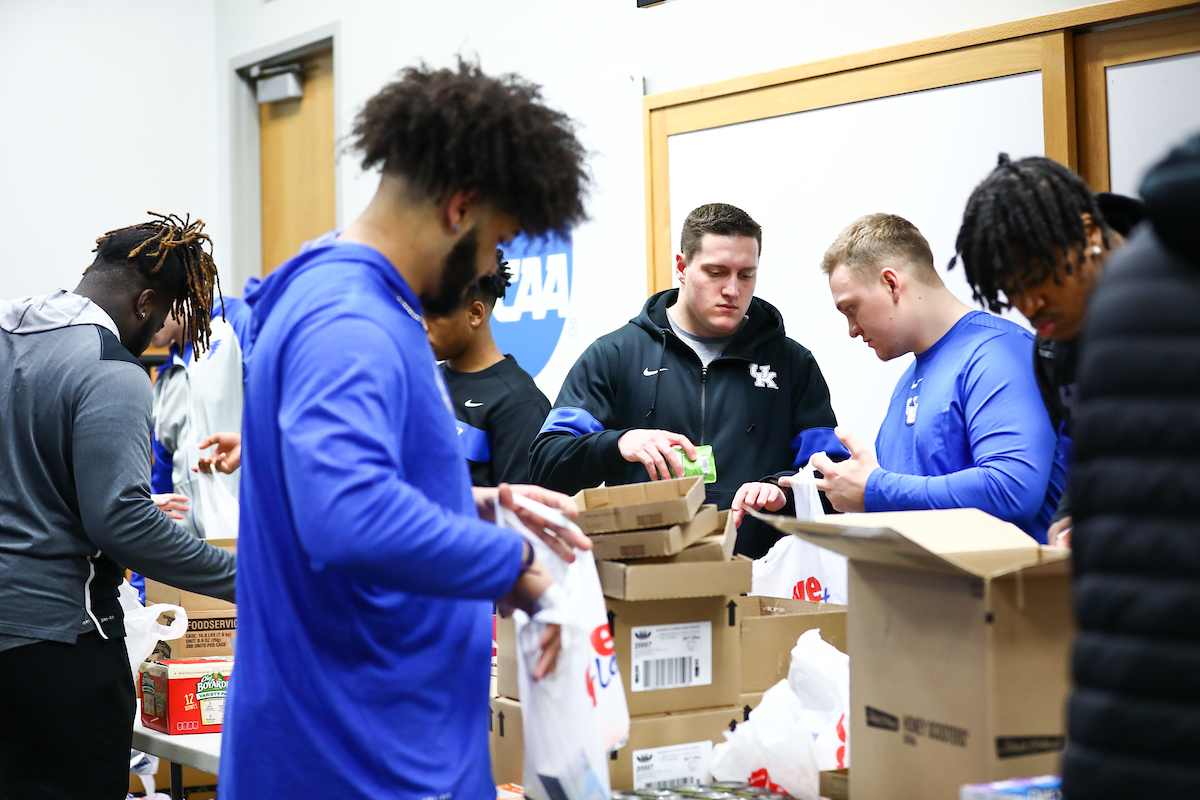 Kentucky football players pack lunches for God’s Pantry Food Bank.

Photo by Elliott Hess | UK Athletics